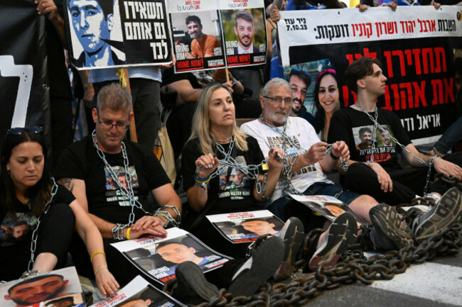 jerusalem-israel-07th-aug-2025-israeli-hostage-families-wear-chains-with-photos-of-hostages-held-in-gaza-at-a-protest-calling-for-the-end-of-the-israel-hamas-war-the-release-of-all-hostages-held