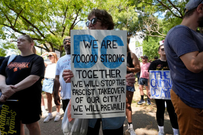 activists-carry-signs-during-a-protest-against-president-donald-trumps-federal-takeover-of-policing-of-the-district-of-columbia-saturday-aug-16-2025-in-washington-ap-photoalex-brandon