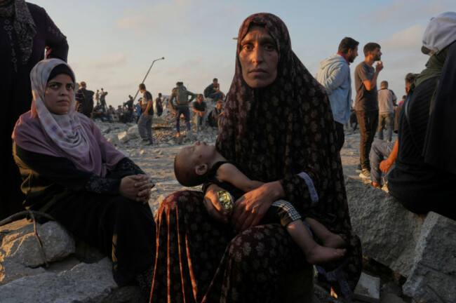 somoud-wahdan-looks-at-the-camera-while-she-and-her-child-wait-for-trucks-of-humanitarian-aid-to-arrive-in-gaza-city-july-25-2025-ap-photoabdel-kareem-hana