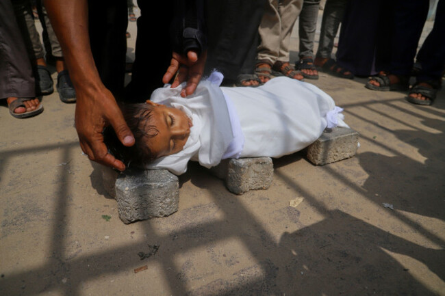 the-body-of-5-year-old-jamal-al-najjar-is-placed-on-the-ground-atop-bricks-before-a-funeral-prayer-after-he-died-at-nasser-hospital-in-khan-younis-southern-gaza-strip-tuesday-aug-12-2025-the-hea