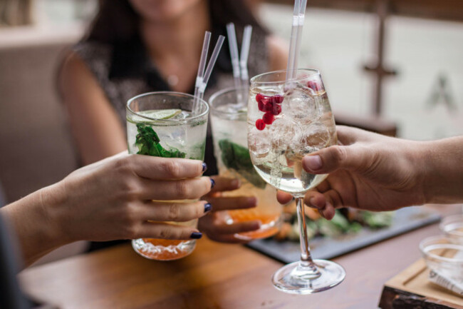 group-of-friends-having-fun-and-drink-cocktails-cheers-glasses-in-the-hands-summer-mood-in-minsk-belarus