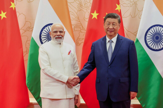in-this-photo-provided-by-indian-prime-ministers-office-indian-prime-minister-narendra-modi-left-and-chinese-president-xi-jinping-shake-hand-before-their-meeting-on-the-sidelines-of-the-shanghai-c