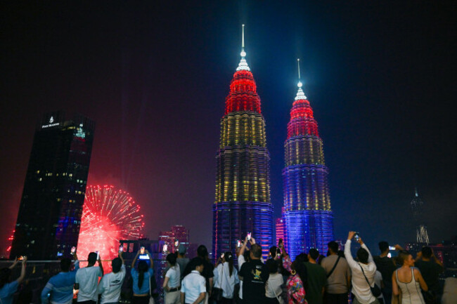 kuala-lumpur-malaysia-31st-aug-2025-people-take-photos-of-fireworks-in-celebration-of-malaysias-68th-anniversary-of-independence-near-the-petronas-twin-towers-in-kuala-lumpur-malaysia-aug-31