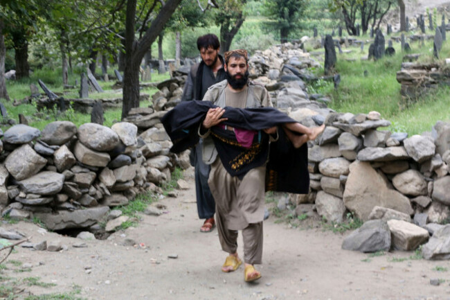 an-injured-person-is-carried-to-a-military-helicopter-that-landed-to-evacuate-injured-victims-of-an-earthquake-that-killed-many-people-and-destroyed-villages-in-eastern-afghanistan-in-mazar-dara-kun
