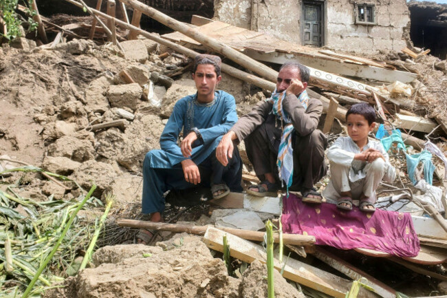 survivors-sit-on-the-rubble-as-civil-defense-workers-and-army-soldiers-search-for-survivors-after-a-powerful-6-0-magnitude-earthquake-struck-eastern-afghanistan-on-sunday-killing-many-people-and-dest