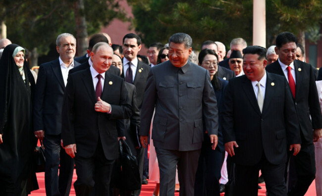 from-left-in-the-front-row-russian-president-vladimir-putin-chinese-president-xi-jinping-and-north-korean-leader-kim-jong-un-walk-after-a-joint-photo-session-of-the-heads-of-foreign-delegations-invi