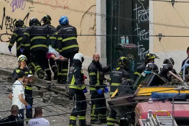 firefighters-carrying-the-body-of-a-person-on-a-stretcher-at-the-site-of-a-derailed-electric-streetcar-in-lisbon-portugal-wednesday-sept-3-2025-ap-photoarmando-franca