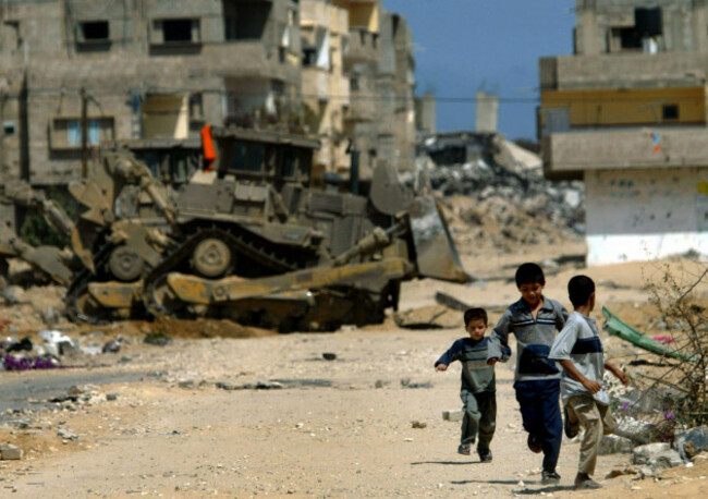 file-palestinian-children-run-for-cover-as-israeli-army-d-9-bulldozers-advance-at-the-rubble-of-previously-demolished-houses-and-damaged-roads-at-the-brazil-neighborhood-of-rafahs-refugee-camp