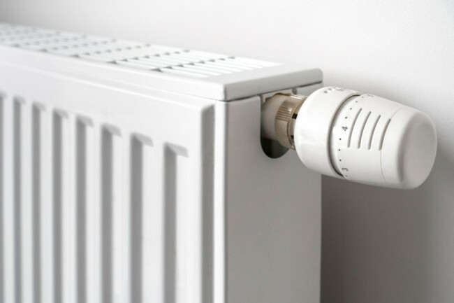 close-up-of-thermostatic-radiator-valve-tvr-fitted-to-household-hot-water-heating-system-radiator-to-control-the-temperature-of-a-room