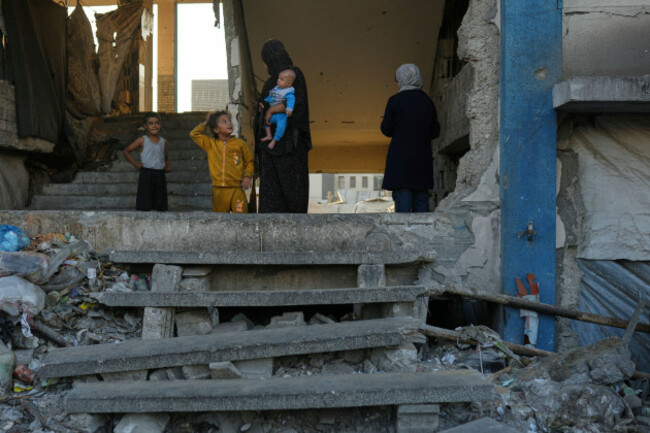 a-displaced-palestinian-woman-holds-her-baby-as-she-talks-with-children-in-a-school-used-as-a-shelter-in-gaza-city-wednesday-aug-27-2025-ap-photojehad-alshrafi