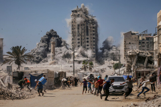 file-palestinians-run-for-cover-during-an-israeli-airstrike-on-a-high-rise-building-in-gaza-city-friday-sept-5-2025-after-the-israeli-army-issued-a-warning-ap-photoyousef-al-zanoun-file