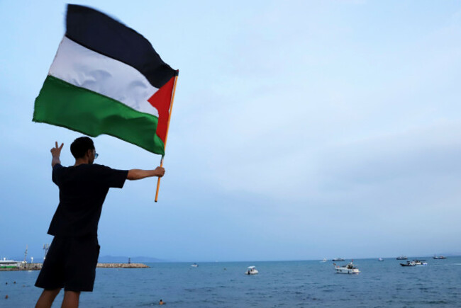 a-protester-waves-a-palestinian-flag-in-support-of-the-the-global-sumud-flotilla-as-it-arrives-at-the-port-of-sidi-bou-said-in-tunis-tunisia-sunday-sept-7-2025-ap-photoanis-mili