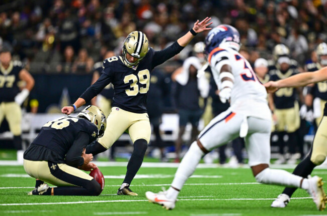 new-orleans-saints-holder-james-burnip-left-places-the-ball-for-place-kicker-charlie-smyth-to-make-a-field-goal-as-denver-broncos-special-teams-player-quinton-newsome-comes-in-to-defend-in-the-secon