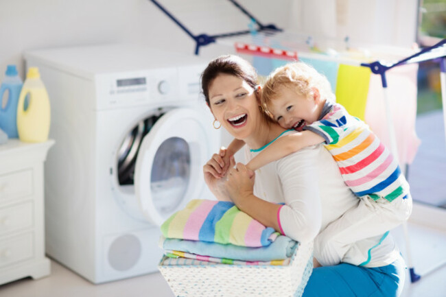 motherandkidsinlaundryroomwithwashingmachineor