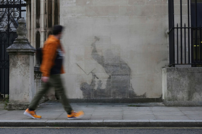 the-remains-of-banksys-latest-artwork-outside-at-the-royal-courts-of-justice-which-shows-a-judge-using-his-gavel-to-strike-a-protester-are-visible-after-an-attempt-to-remove-it-in-london-england