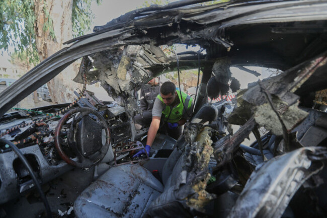 a-civil-defense-worker-inspects-a-damaged-car-hit-sunday-in-an-israeli-drone-strike-that-killed-four-members-of-the-same-family-in-bint-jbeil-town-southern-lebanon-monday-sept-22-2025-ap-photo