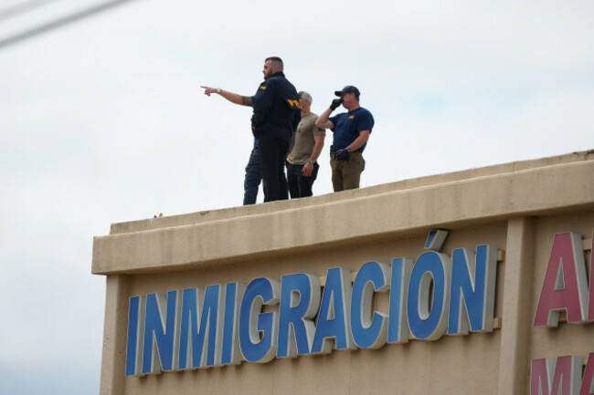 law-enforcement-agents-look-around-the-roof-of-an-apartment-building-near-the-scene-of-a-shooting-at-a-u-s-immigration-and-customs-enforcement-office-in-dallas-on-wednesday-sept-24-2025-ap-photo