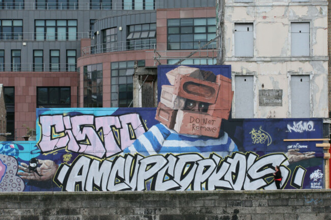 dublin-ireland-24th-june-2025-lmage-of-the-do-not-remove-art-mural-covered-in-large-tagging-graffiti-along-ormond-quay-in-dublin-city-centre-depicting-street-life-in-the-irish-capital