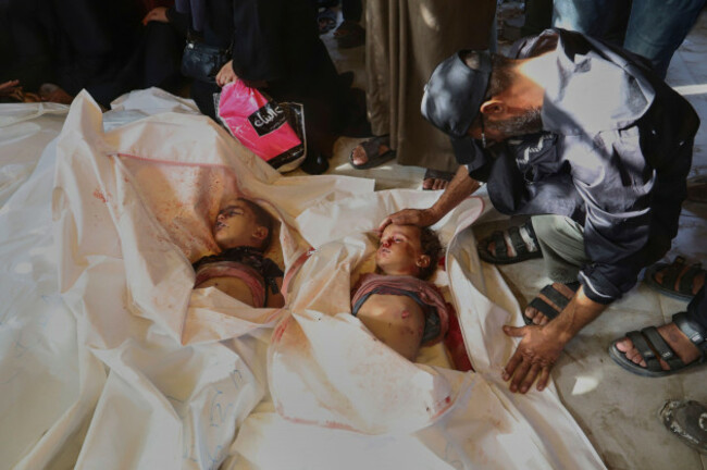 eds-note-graphic-content-majed-al-mashwakhi-mourns-over-the-bodies-of-his-grandchildren-yusuf-eid-4-left-and-saif-eid-2-right-who-were-killed-in-an-israeli-airstrike-during-their-funeral-at