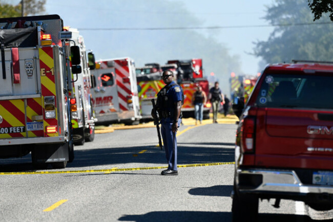 a-michigan-state-trooper-stands-guard-along-mccandlish-road-near-a-shooting-that-took-place-at-the-church-of-jesus-christ-of-latter-day-saints-sunday-sept-28-2025-in-grand-blanc-mich-ap-photo