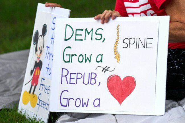 a-fired-government-worker-holds-signs-about-the-looming-government-shutdown-tuesday-sept-30-2025-on-capitol-hill-in-washington-during-a-rally-with-former-federal-employees-ap-photojacquelyn-m