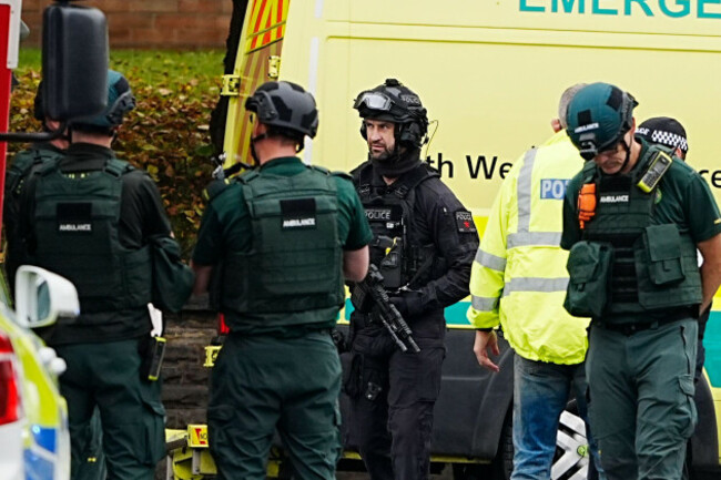 an-armed-police-officer-with-members-of-the-ambulance-service-at-the-scene-of-an-incident-at-heaton-park-hebrew-congregation-synagogue-in-crumpsall-manchester-where-police-have-shot-a-suspect-after