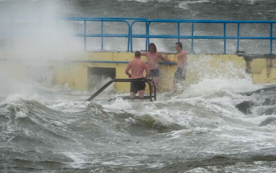 people-on-blackrock-diving-tower-in-salthill-galway-storm-amy-will-bring-damaging-winds-to-the-island-of-ireland-with-every-county-under-weather-warnings-on-friday-wind-speeds-could-reach-up-to-80m
