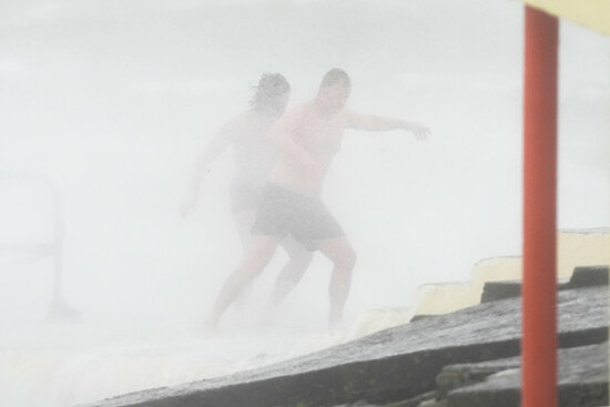 people-on-blackrock-diving-tower-in-salthill-galway-storm-amy-will-bring-damaging-winds-to-the-island-of-ireland-with-every-county-under-weather-warnings-on-friday-wind-speeds-could-reach-up-to-80m