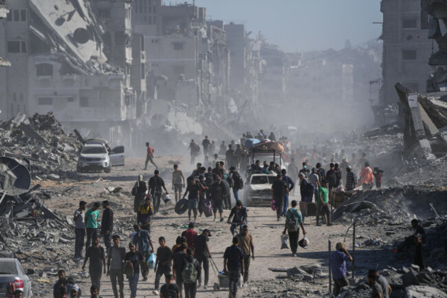 displaced-palestinians-carry-their-belongings-as-they-walk-along-the-heavily-damaged-al-jalaa-street-in-gaza-city-saturday-oct-11-2025-after-israel-and-hamas-agreed-to-a-pause-in-their-war-and-th