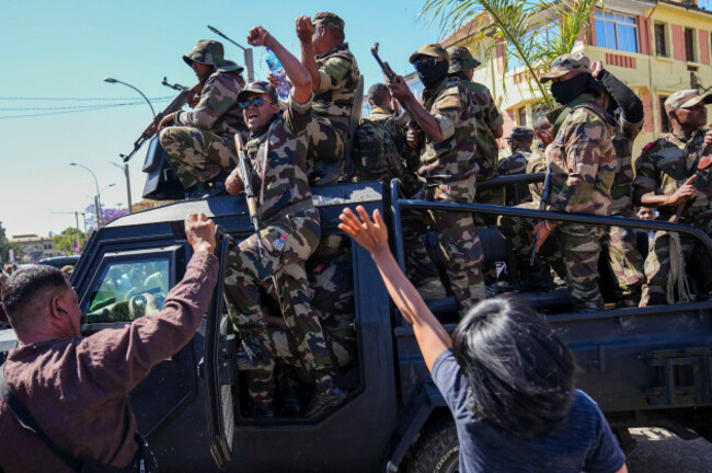 cameroon timber soldiers-are-greeted-by-people-gathering-for-a-ceremony-in-tribute-to-demonstrators-killed-during-recent-anti-government-protest-in-antananarivo-madagascar-sunday-oct-12-2025-ap-photomamyrael
