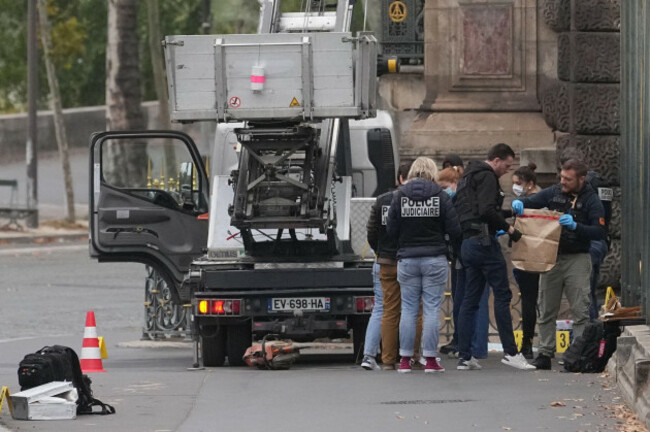police-officers-look-for-clues-by-a-basket-lift-used-by-thieves-sunday-oct-19-2025-at-the-louvre-museum-in-paris-ap-photothibault-camus