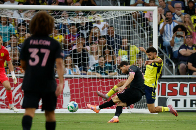nashville-tn-october-18-inter-miami-forward-lionel-messi-10-connects-with-his-left-foot-for-a-goal-in-front-of-nashville-sc-midfielder-patrick-yazbek-8-during-a-match-between-nashville-sc-and-in