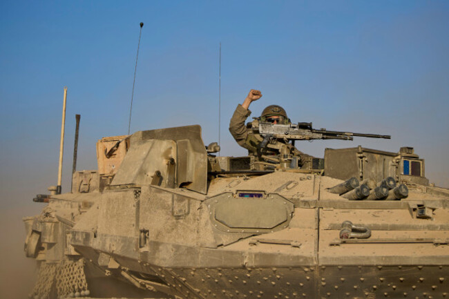 an-israeli-soldier-raises-his-fist-from-a-tank-along-the-israeli-gaza-border-as-seen-from-southern-israel-monday-oct-20-2025-ap-photoohad-zwigenberg