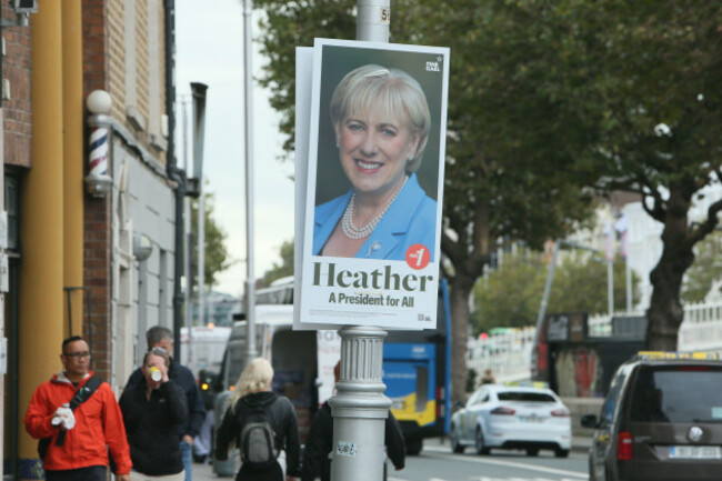 dublin-ireland-07th-october-2025-people-walk-past-fine-gael-candidate-heather-humphreys-election-poster-for-the-2025-irish-presidential-election-on-a-dublin-city-street-pole