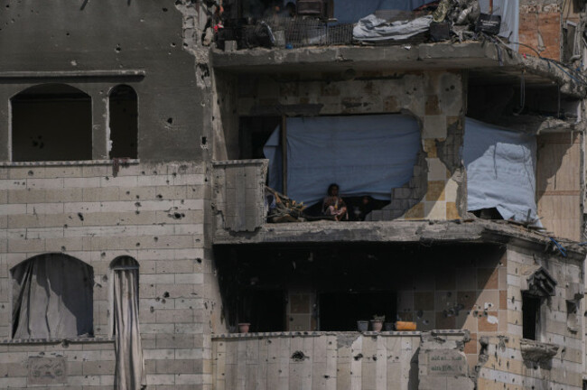 palestinian-children-stand-in-a-heavily-damaged-building-turned-into-a-shelter-in-the-al-shati-camp-in-gaza-city-friday-oct-24-2025-ap-photoabdel-kareem-hana
