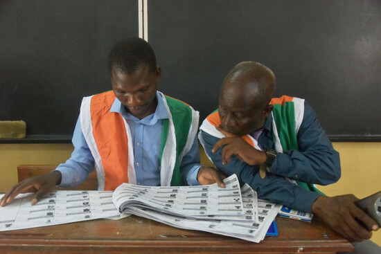 electoral-officials-check-names-of-voters-during-the-presidential-elections-at-a-polling-station-in-cocody-ivory-coast-saturday-oct-25-2025-ap-photodiomande-ble-blonde