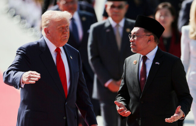 u-s-president-donald-trump-talks-with-malaysia-prime-minister-anwar-ibrahim-as-he-arrives-at-kuala-lumpur-international-airport-to-attend-the-47th-association-of-southeast-asian-nations-asean-summi