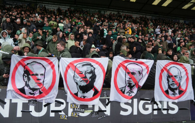 celtic-fans-hold-images-of-the-teams-board-left-to-right-christopher-mckay-peter-lawwell-michael-nicholson-and-dermot-desmond-as-they-protest-about-the-ownership-of-the-club-during-the-william-h
