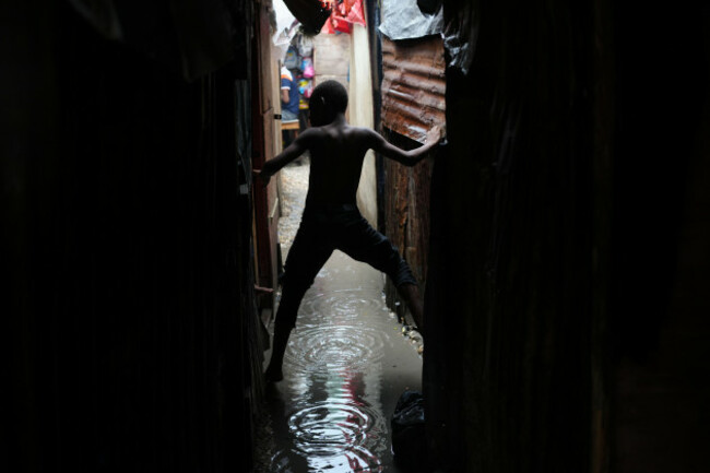 a-boy-moves-along-an-alleyway-flooded-by-rain-brought-by-hurricane-melissa-at-a-shelter-for-families-displaced-by-gang-violence-in-port-au-prince-haiti-wednesday-oct-29-2025-ap-photoodelyn-jos