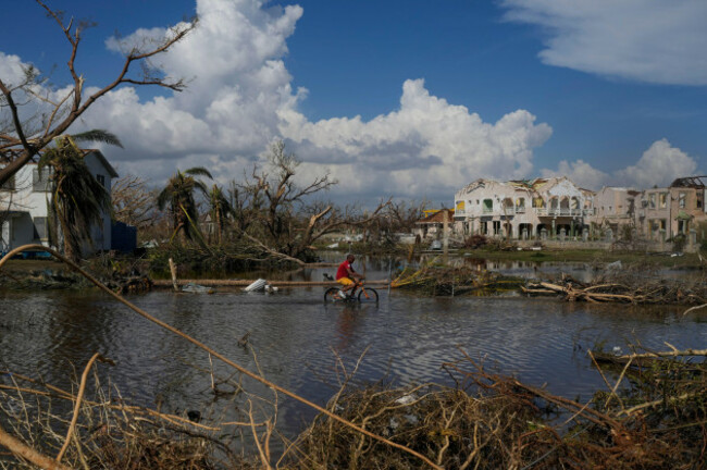 a-man-rides-his-bicycle-through-an-inundated-street-in-black-river-jamaica-thursday-oct-30-2025-in-the-aftermath-of-hurricane-melissa-ap-photomatias-delacroix