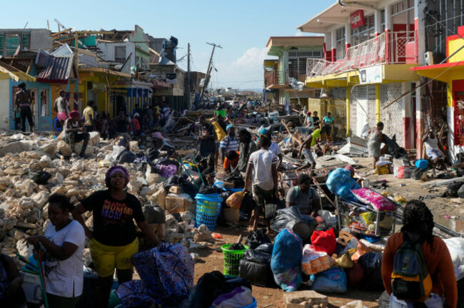residents-gather-amid-debris-in-the-aftermath-of-hurricane-melissa-on-a-street-in-black-river-jamaica-thursday-oct-30-2025-ap-photomatias-delacroix