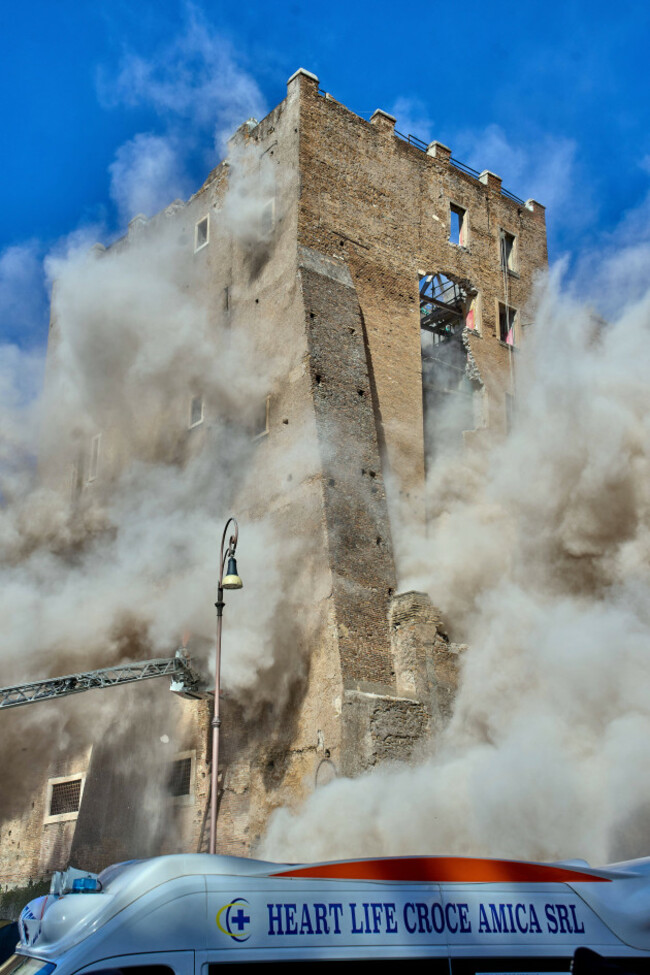 the-medieval-tower-torre-dei-conti-near-the-roman-forum-is-engulfed-by-a-cloud-of-debris-from-a-second-collapse-after-it-had-partially-collapsed-during-renovation-works-in-rome-italy-monday-nov-3