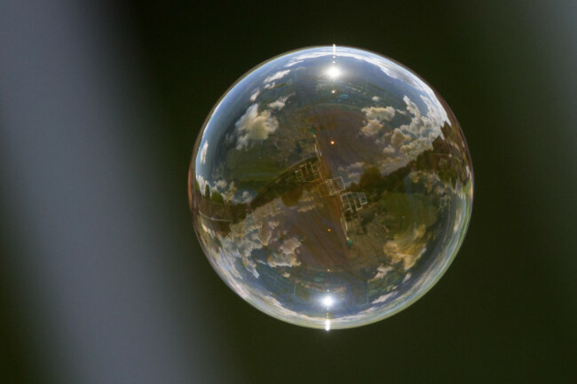 a-bubble-floats-by-on-a-warm-summers-day-reflecting-the-world-around-it