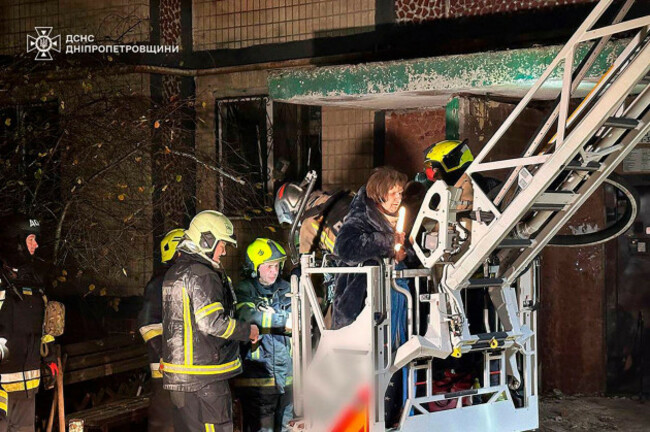 in-this-photo-provided-by-the-ukrainian-emergency-service-firefighters-evacuate-a-resident-following-a-russian-rocket-attack-that-hit-a-multi-storey-apartment-building-in-dnipro-ukraine-saturday-n