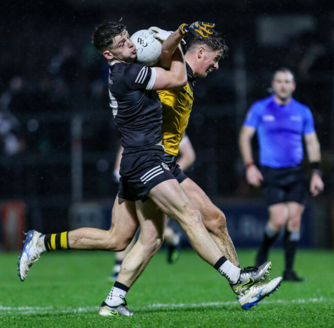 anthony-morgan-gathers-the-ball-under-pressure-from-aodhan-donaghy