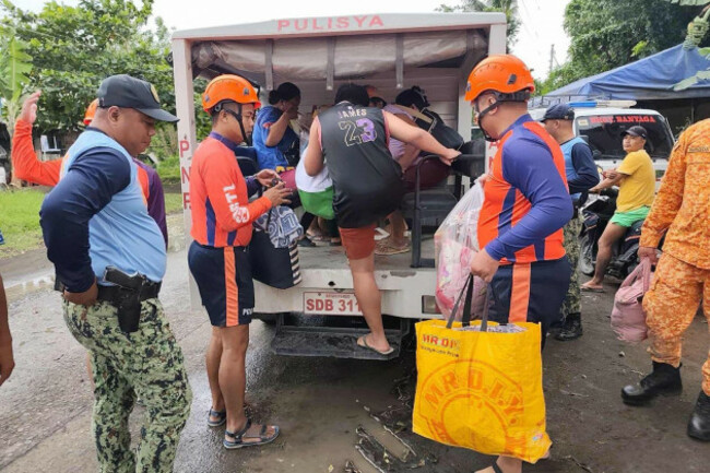 in-this-photo-provided-by-the-philippine-coast-guard-rescuers-evacuate-people-to-safer-grounds-in-quezon-province-eastern-philippines-as-typhoon-fung-wong-enters-the-country-on-sunday-nov-9-2025