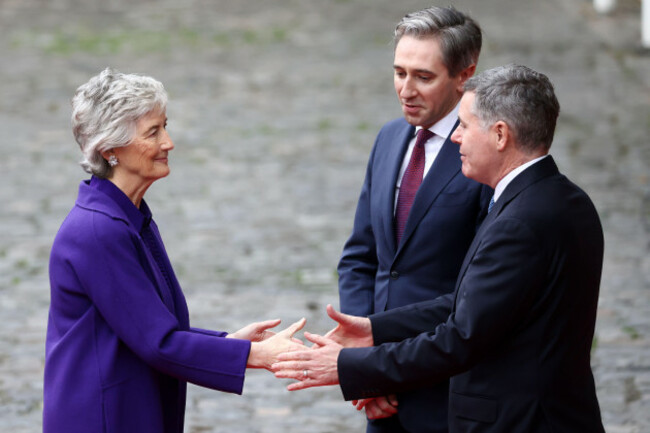 tanaiste-of-ireland-simon-harris-and-paschal-donohoe-minister-for-finance-of-ireland-right-welcome-irelands-president-elect-catherine-connolly-as-she-arrives-for-the-inauguration-ceremony-in-dubli