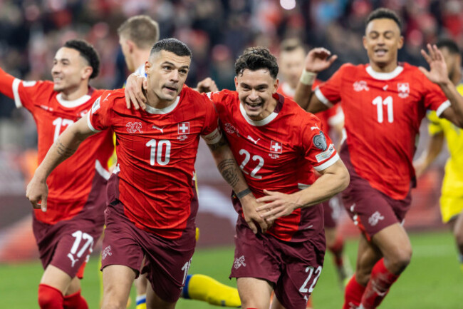 switzerlands-granit-xhaka-second-from-left-celebrates-with-teammates-ruben-vargas-left-fabian-rieder-center-and-dan-ndoye-right-after-scoring-on-a-penalty-during-the-world-cup-2026-group-b-qu