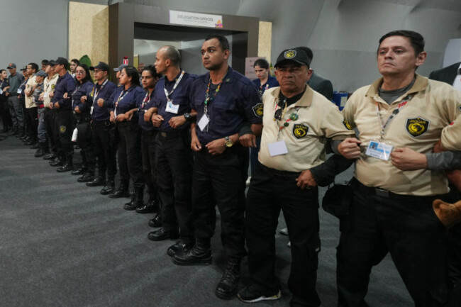 officials-form-a-chain-to-not-allow-attendees-past-after-attendees-were-asked-to-leave-the-venue-for-the-cop30-u-n-climate-summit-thursday-nov-20-2025-in-belem-brazil-ap-photoandre-penner