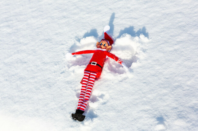 a-naughty-christmas-elf-making-snow-angles-in-the-fresh-winter-snow-elf-on-the-shelf-naughty-christmas-mischievous-elf-concept